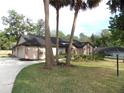 Well-maintained single story home with a beautiful lawn, mature trees, and an inviting concrete driveway at 4215 Se 24Th Ter, Ocala, FL 34480