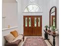 Inviting foyer featuring double doors, high ceilings, and decorative accents on the table at 4893 Sw 4Th Cir, Ocala, FL 34471