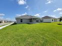 A spacious backyard with a covered patio offers plenty of room for outdoor activities at 5892 Sw 82Nd Ln, Ocala, FL 34476