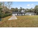 Modern home with a large front yard and driveway at 13283 Se 45Th Ave, Belleview, FL 34420