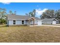 Two-story home with gray siding and a 1-car garage, next to a similar house at 13526 Sw 106Th Pl, Dunnellon, FL 34432