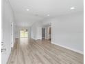Bright living room with vaulted ceilings, recessed lighting, and sliding glass doors to the backyard at 14363 Sw 27 St, Ocala, FL 34481