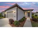 Single-story home with attached garage, landscaping, and walkway at dusk at 6014 Sw 93Rd Cir, Ocala, FL 34481