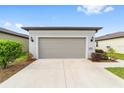 Attached garage with light gray door at 6014 Sw 93Rd Cir, Ocala, FL 34481