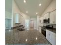 Modern kitchen featuring granite countertops, stainless appliances and recessed lighting at 8949 Se 159Th Ln, Summerfield, FL 34491