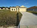 Well-maintained single-Gathering home with a long driveway and a welcoming front yard at 3127 Ne 45Th Ave, Ocala, FL 34470