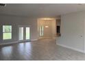 Bright, open-concept living room with tile flooring and backyard access at 7143 Sw 179Th Court Rd, Dunnellon, FL 34432