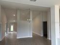 Spacious living room showcasing tile floors, recessed lighting, and an elegant chandelier at 7173 Sw 179Th Court Rd, Dunnellon, FL 34432
