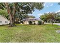 View of the exterior side and well-maintained lawn at 9068 Sw 82Nd Ter # A, Ocala, FL 34481