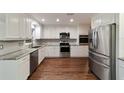 Modern kitchen featuring white cabinets, stainless steel appliances, and ample countertop space at 9068 Sw 82Nd Ter # A, Ocala, FL 34481