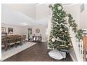 Bright living room featuring a tall Christmas tree and hardwood floors at 4535 Se 32Nd Pl, Ocala, FL 34480