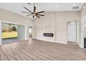 Bright living room with modern fireplace, high ceilings, and glass doors leading to the outside at 17887 Sw 72Nd Street Rd, Dunnellon, FL 34432