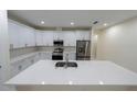 Modern kitchen featuring white cabinets and quartz countertops at 13850 Se 42Nd Ave, Summerfield, FL 34491