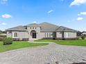 Gray two-story house with circular driveway and landscaping at 6892 Nw 54Th Loop, Ocala, FL 34482