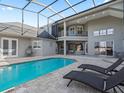 Relaxing pool area with screened enclosure and lounge chairs at 6892 Nw 54Th Loop, Ocala, FL 34482