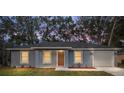 Charming home showcasing a freshly painted exterior, manicured lawn, and a welcoming front entrance at 13212 Sw 113 Ln, Dunnellon, FL 34432