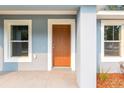 A close up front porch featuring a modern exterior door and fresh paint on the exterior walls at 13212 Sw 113 Ln, Dunnellon, FL 34432