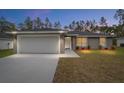 Beautiful single-Gathering home featuring a two-car garage and a well-maintained lawn, perfect for suburban living at 13234 Sw 113 Ln, Dunnellon, FL 34432