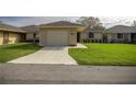 A charming one-story home with an attached garage, and a perfectly manicured lawn at 10817 Se 51St Ave, Belleview, FL 34420