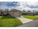 Charming single-story home with a well-kept lawn, attached garage, and an inviting entrance at 10817 Se 51St Ave, Belleview, FL 34420