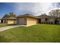 Charming single-story home boasting a well-manicured lawn, attached garage, and welcoming curb appeal at 10817 Se 51St Ave, Belleview, FL 34420