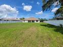 Large backyard featuring a well-maintained lawn and surrounded by a white vinyl fence at 11610 Sw 59Th Terrace, Ocala, FL 34476