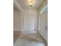 Bright foyer features wood-look tile flooring and white doors at 11610 Sw 59Th Terrace, Ocala, FL 34476