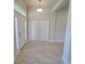 Inviting foyer with neutral tile flooring, a front door with sidelight, and a view into other rooms at 11610 Sw 59Th Terrace, Ocala, FL 34476