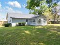 Nice backyard showcasing a home with an enclosed sunroom, providing extra space and lots of natural light at 4360 Se 58Th Pl, Ocala, FL 34480