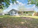 Backyard featuring a patio, mature trees and a lush lawn at 4360 Se 58Th Pl, Ocala, FL 34480