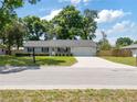 Charming home with a well-maintained lawn, neutral siding, and a wide driveway leading to an attached garage at 4360 Se 58Th Pl, Ocala, FL 34480