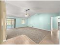 Bright and airy living room with a ceiling fan, sliding glass doors, and carpeted flooring for comfort at 4219 Ne 33Rd Ave, Ocala, FL 34479