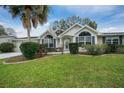 Close up shot of charming single-story home with beautiful landscaping and inviting curb appeal at 8150 Sw 108Th St, Ocala, FL 34481
