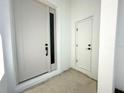 View of the sleek, white front door with black hardware and sidelight at 14711 Sw 69Th Court Rd, Ocala, FL 34473