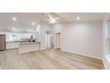 Bright, open-concept living space featuring light wood floors and access to the modern kitchen at 21114 Sw Peach Blossom St, Dunnellon, FL 34431