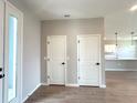 Foyer featuring wood-look tile flooring, coat closets, and an open view into the kitchen and living area at 3015 Sw 132Nd St, Ocala, FL 34473