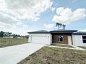 Front exterior view of this modern one-story house with an attached two car garage at 3547 Sw 130Th Lane Rd, Ocala, FL 34473