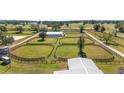 Aerial view of property showing multiple round pens and barn at 10555 W Highway 40, Ocala, FL 34482