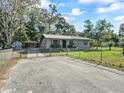 Charming single-story home featuring a metal roof and chain-link fence at 2605 Ne 14Th Ave, Ocala, FL 34470