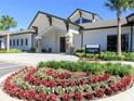 The Stonewater Club features a well-manicured lawn, flowers, stone accents, and a covered entryway at 7066 Sw 91St Ct, Ocala, FL 34481