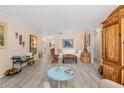 Living room features a white couch, wooden chairs, and light flooring at 8625 Sw 94Th Ln # G, Ocala, FL 34481