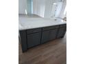 Modern kitchen island with dark gray cabinetry, white countertops, and brushed gold hardware at 5912 Ne 57Th N Loop, Silver Springs, FL 34488