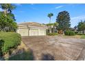 Beautiful home showcasing a brick driveway, a three-car garage, and lush landscaping at 17819 Sw 61St Lane Rd, Dunnellon, FL 34432