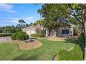Charming single-story home with a beautifully landscaped front yard, stone accents, and a three car garage at 17819 Sw 61St Lane Rd, Dunnellon, FL 34432