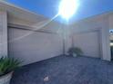 Two-car garage with light tan doors and paver driveway at 3642 Nw 55Th Cir, Ocala, FL 34482