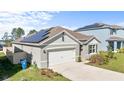 View of a single Gathering home featuring newly installed solar panels on the roof at 547 Tanaro Ln, Haines City, FL 33844