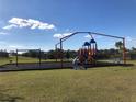 playground with swings and climbing structures at 547 Tanaro Ln, Haines City, FL 33844