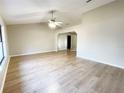 Bright living room featuring light wood floors and a vaulted ceiling at 12467 Se 62Nd Ave, Belleview, FL 34420