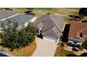 Aerial view of a well maintained single Gathering home featuring a brick paved driveway and manicured lawn at 16331 Sw 12Th Ter, Ocala, FL 34473