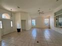 Bright living room featuring tile floors, high ceilings, and natural light from large windows at 6688 Sw 113Th Pl, Ocala, FL 34476